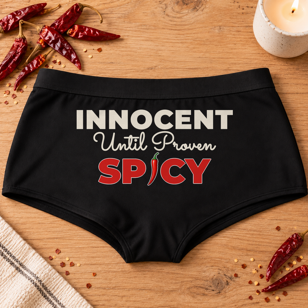 Innocent Until Proven Spicy panties – black boyshort underwear with "Innocent Until Proven Spicy" saying, lifestyle photo
