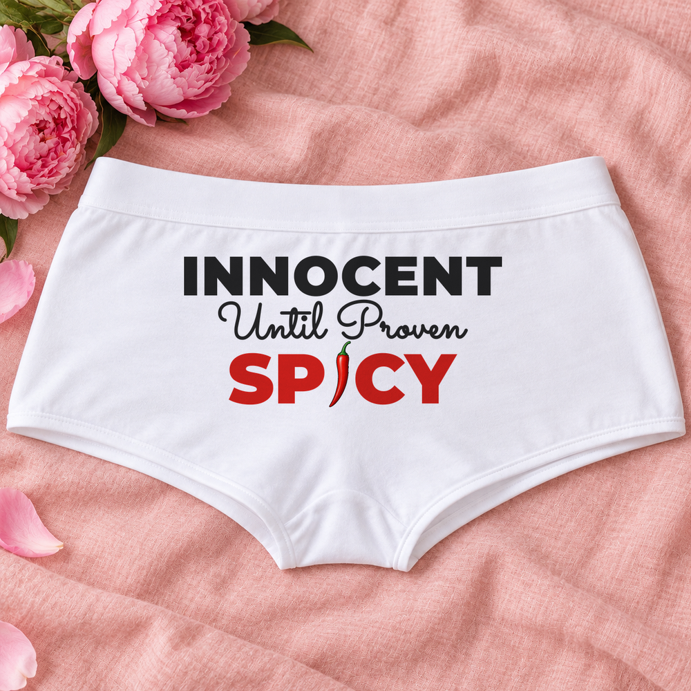 Innocent Until Proven Spicy panties – white boyshort underwear with "Innocent Until Proven Spicy" saying, lifestyle photo