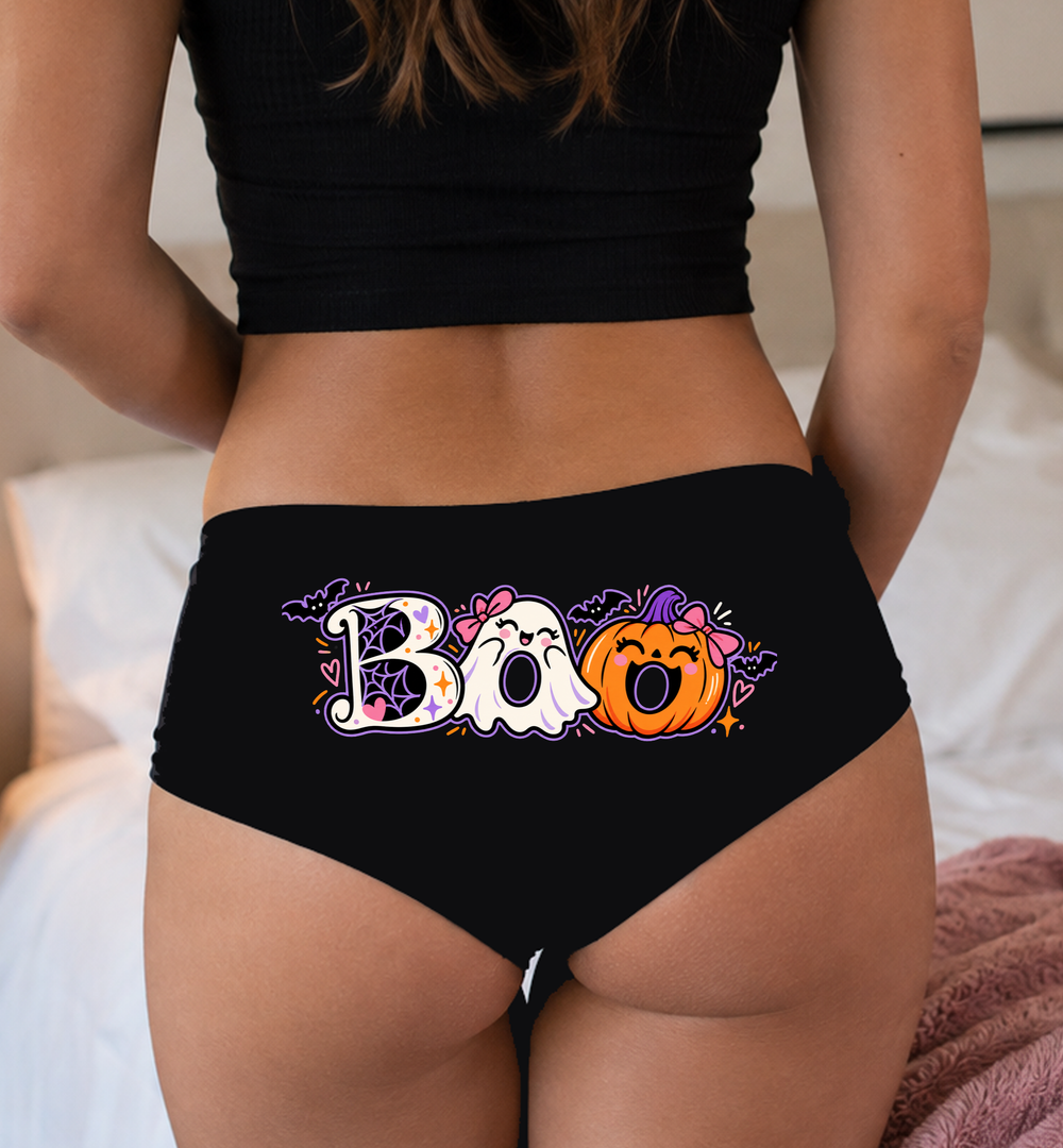 Model in a top wearing black boyshorts with the ghost-and-pumpkin BOO print
