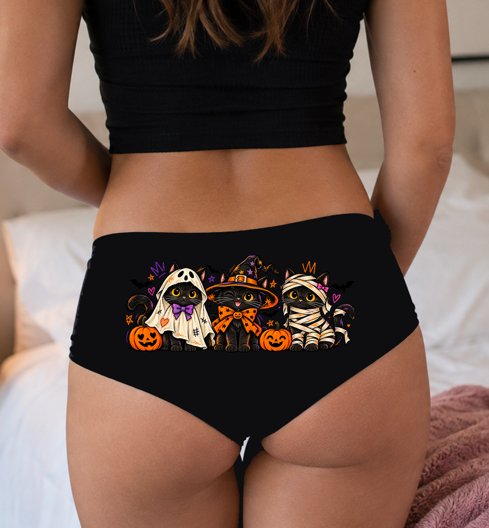 Model in a top wearing black boyshorts with the three Halloween black cats print