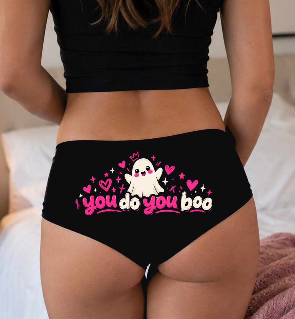 Model in a top wearing black boyshorts with the you do you boo print