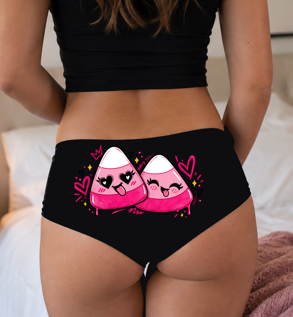 Model in a top wearing black boyshorts with the white-tip candy corn print
