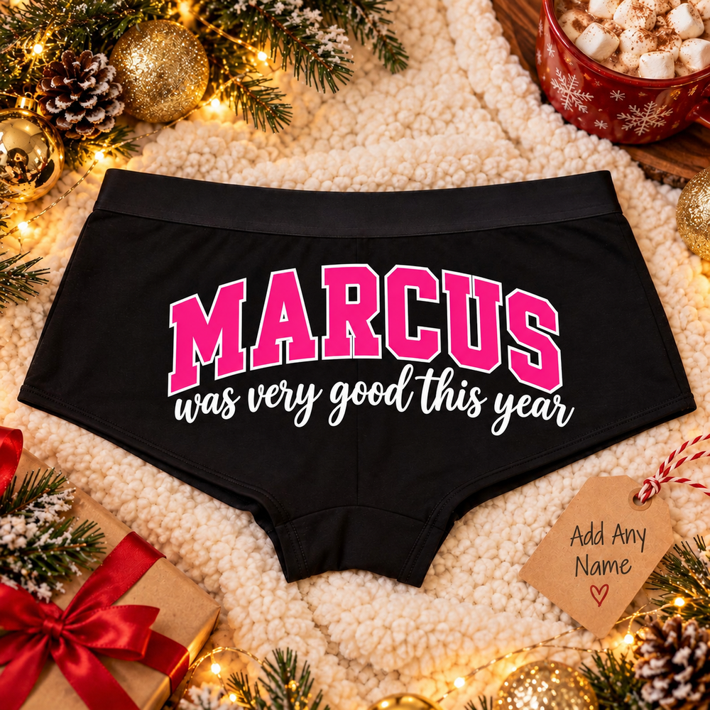 Black Good This Year custom name boyshort panties with pink name lettering on a cozy Christmas blanket