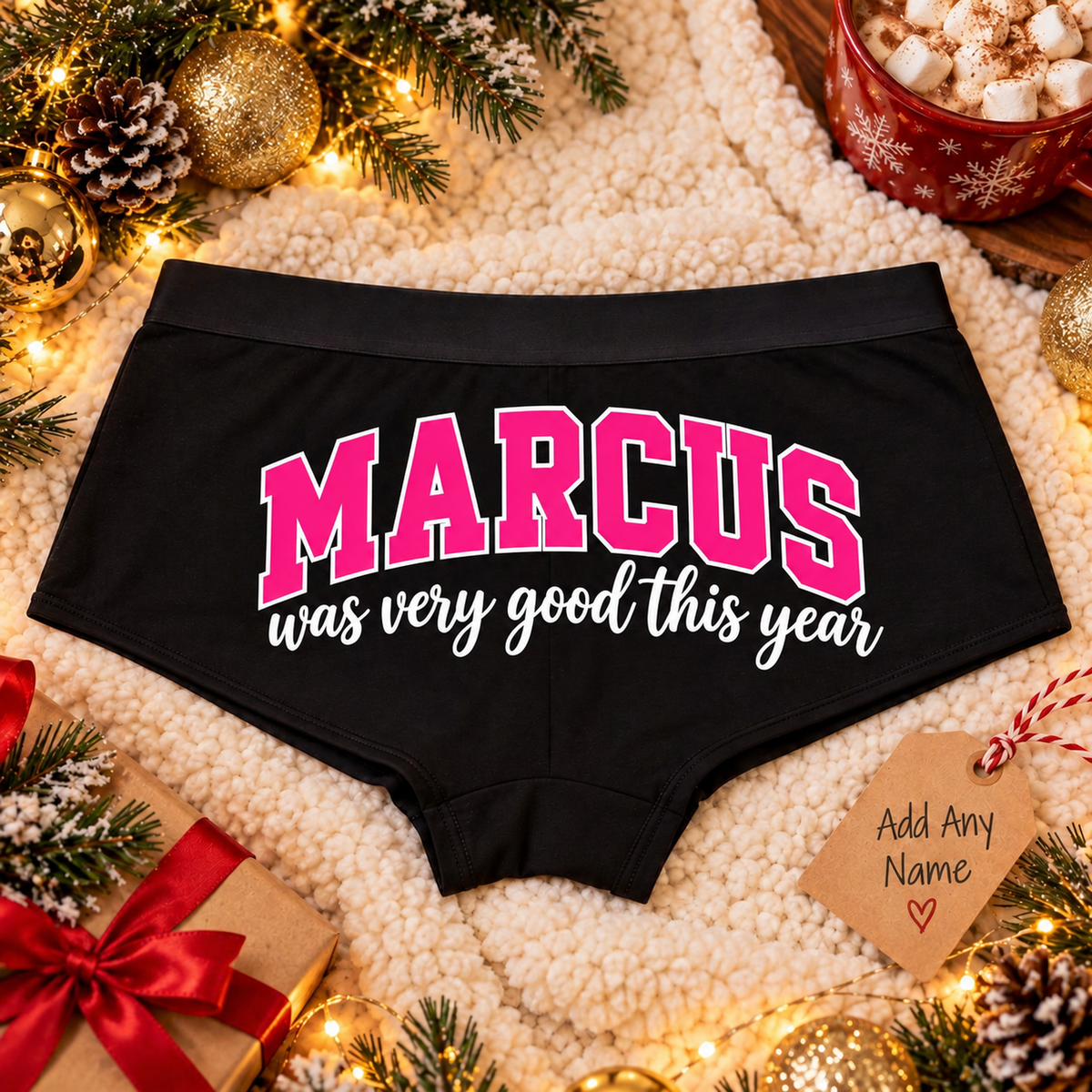 Black Good This Year custom name boyshort panties with pink name lettering on a cozy Christmas blanket