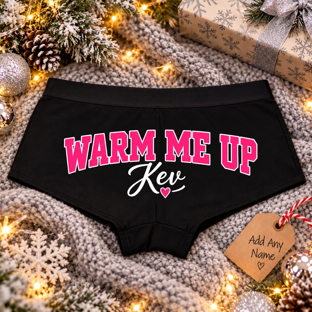 Black Warm Me Up custom name boyshort panties with pink lettering and heart on a cozy Christmas knit