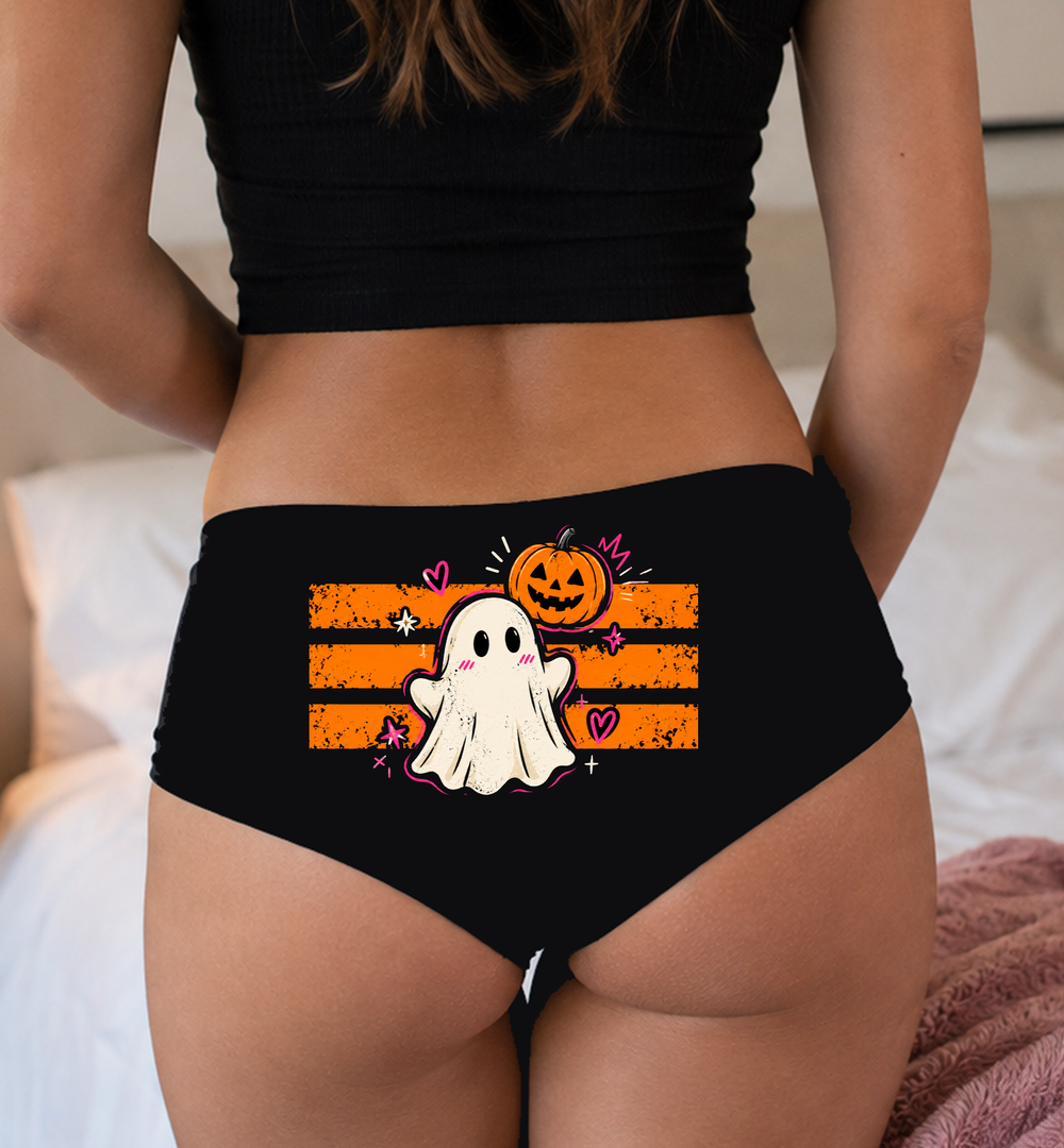 Model in a top wearing black boyshorts with the orange stripe ghost print