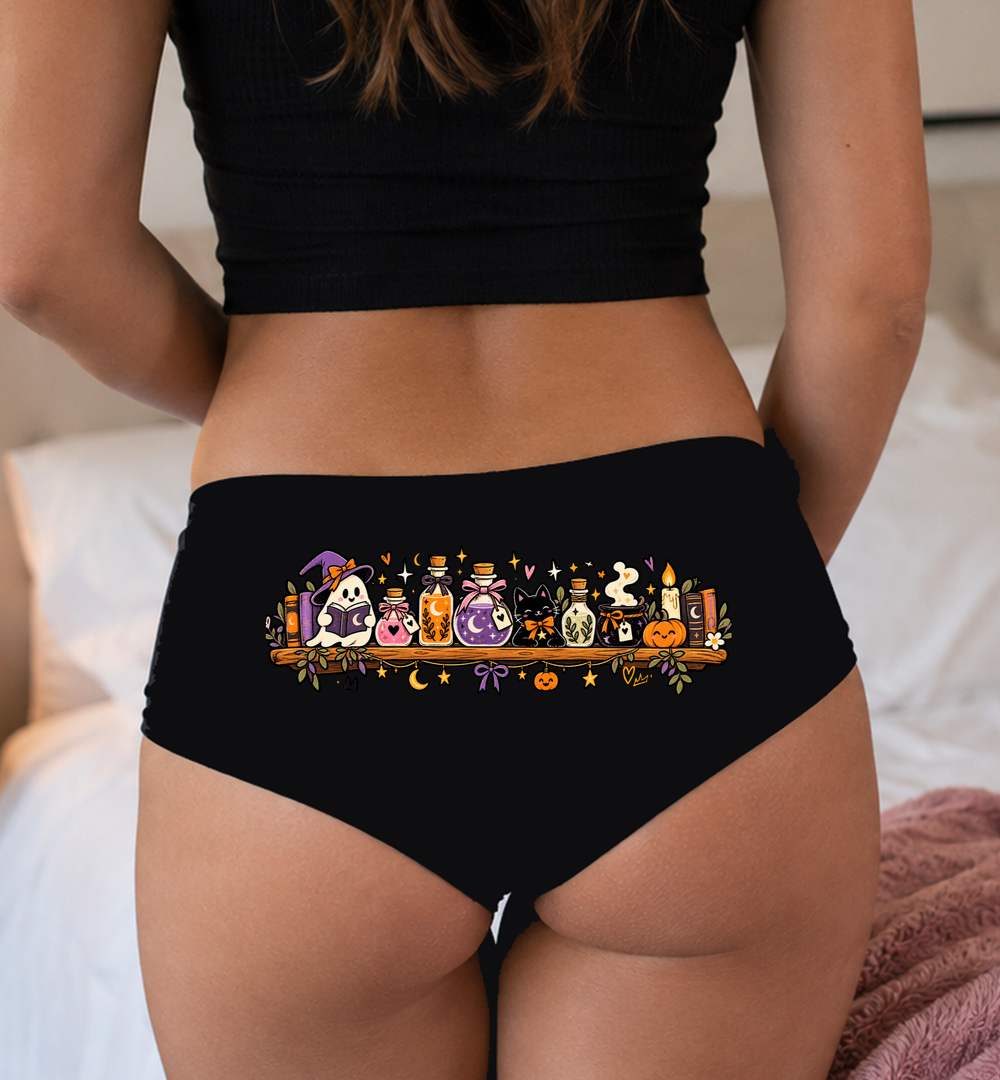 Model in a top wearing black boyshorts with the potion shelf print