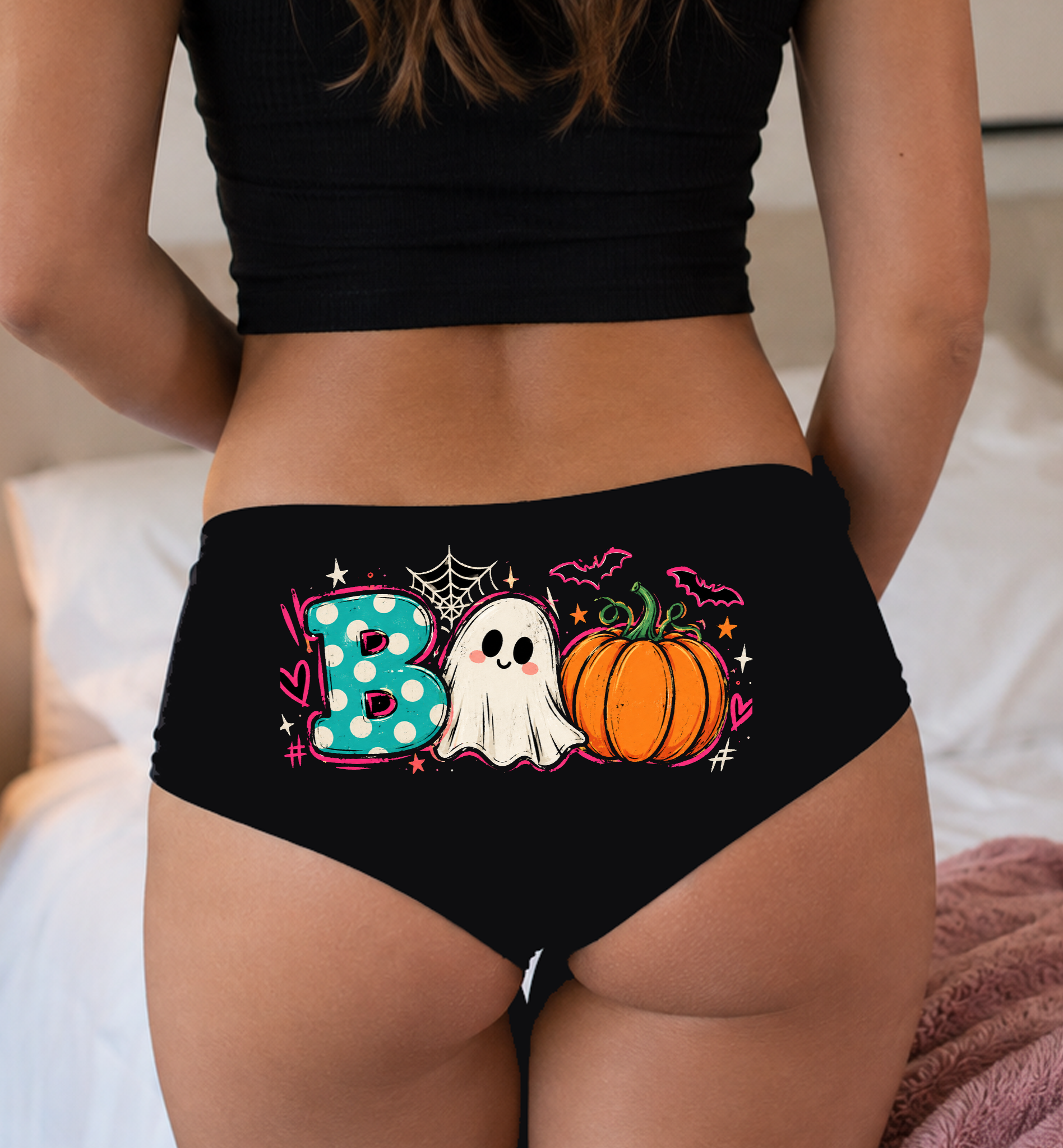 Model in a top wearing black boyshorts with the polka-dot BOO ghost and pumpkin print
