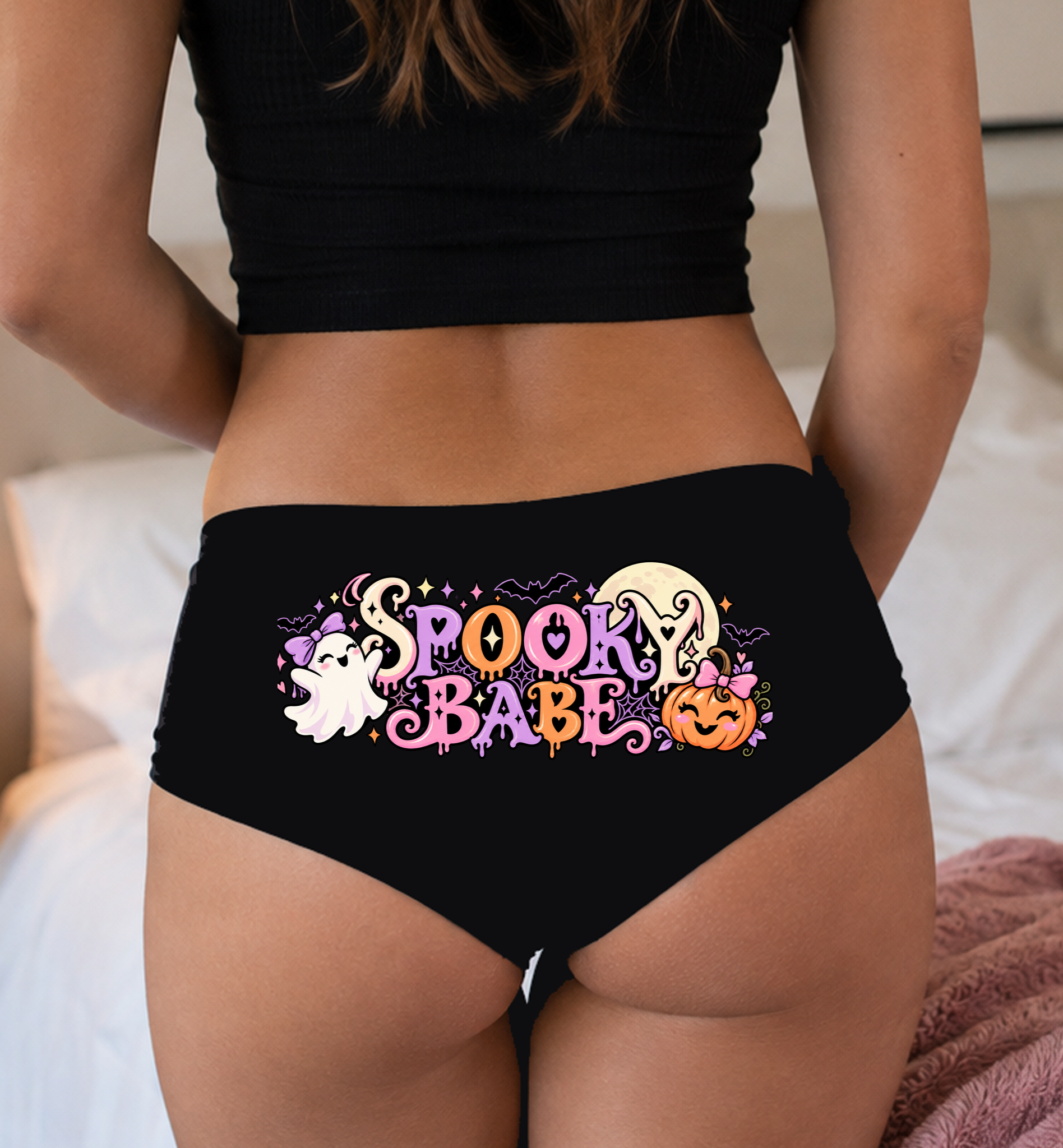Model in a top wearing black boyshorts with the Spooky Babe lettering print