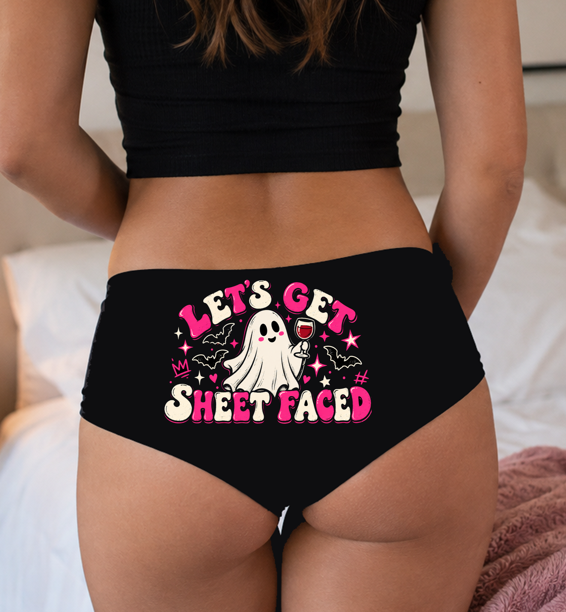 Model in a top wearing black boyshorts with the Let's Get Sheet Faced print