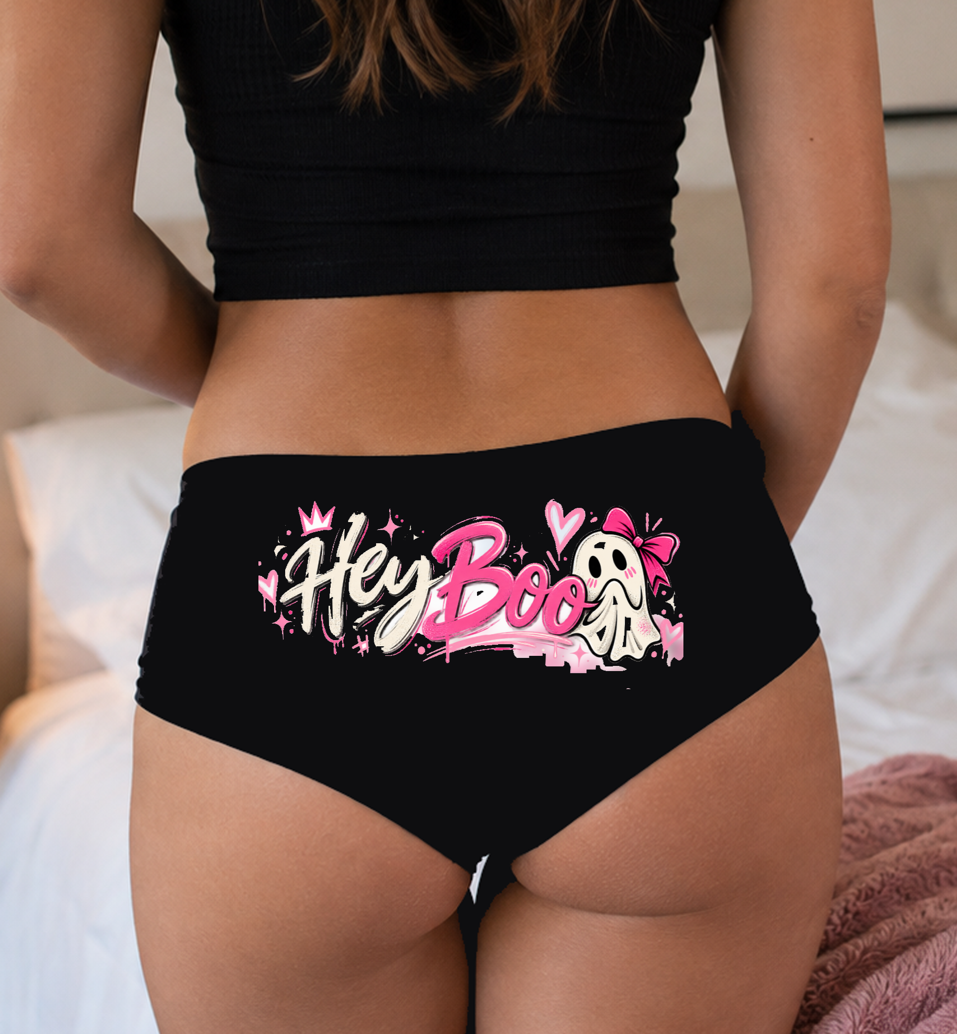 Model in a top wearing black boyshorts with the single-ghost Hey Boo script print