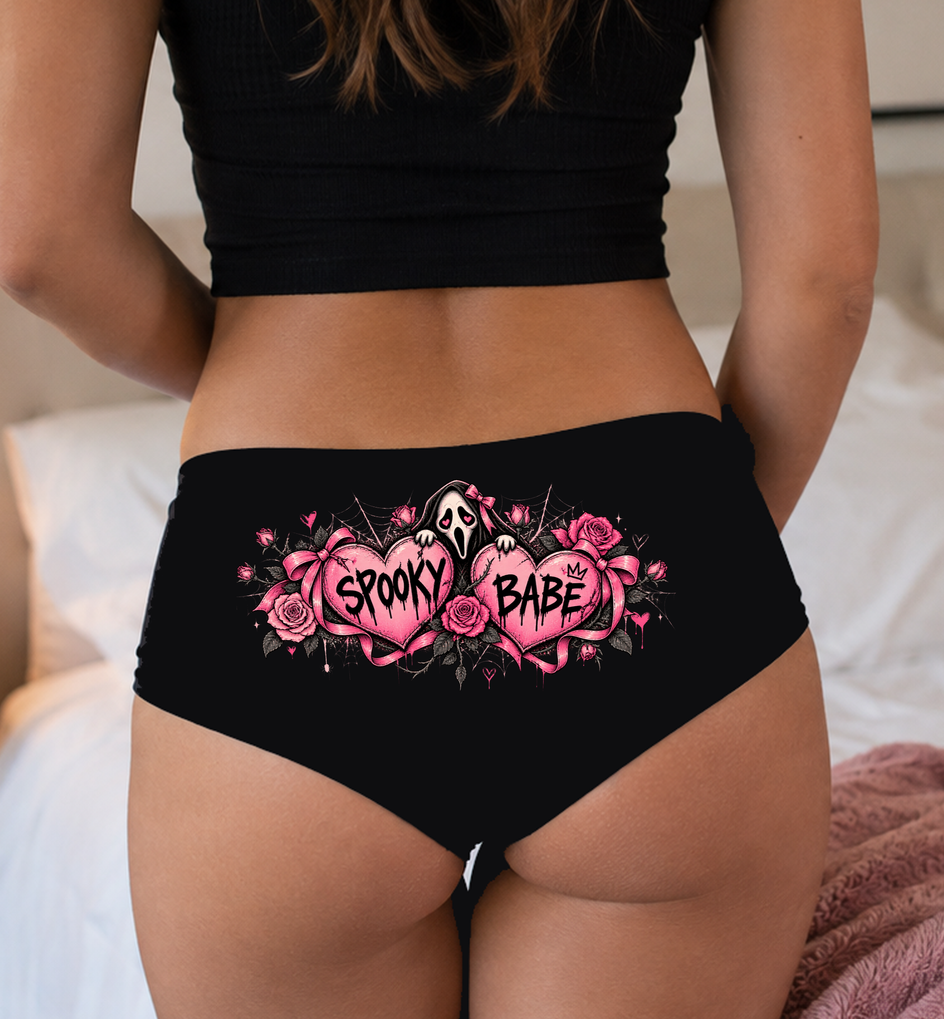 Model in a top wearing black boyshorts with the Spooky Babe pink hearts print