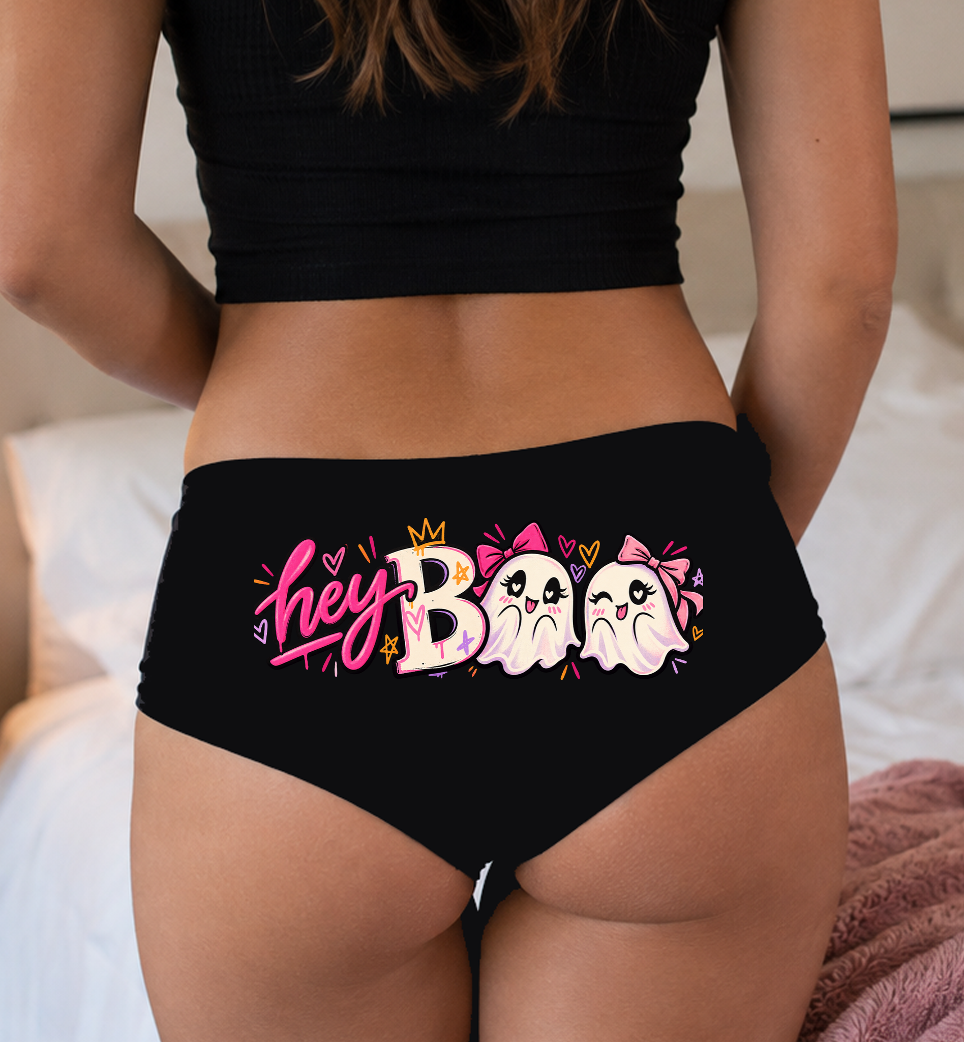 Model in a top wearing black boyshorts with the hey BOO two-ghost print