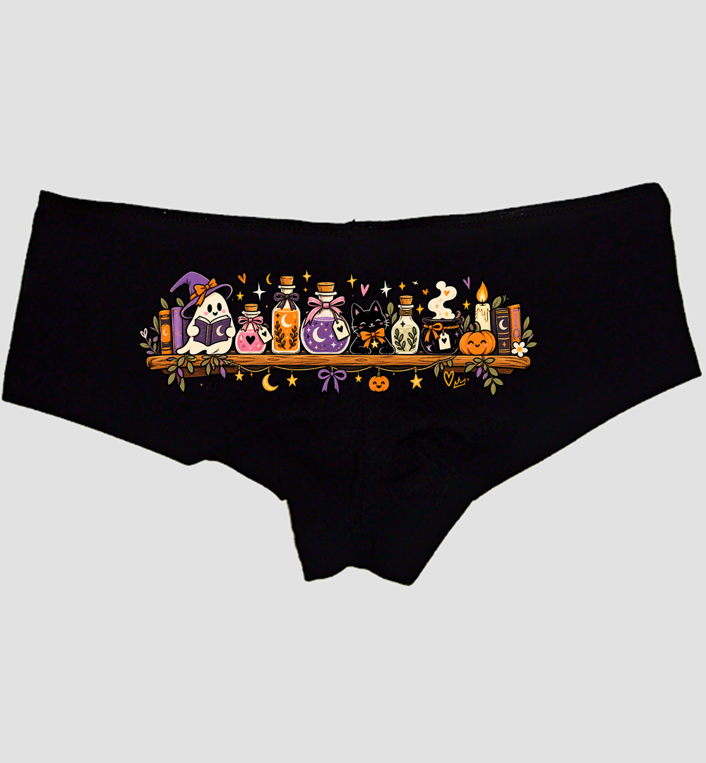 Black boyshort panties with a Halloween potion shelf, reading ghost, black cat, and candle — Sexy Girl Rock